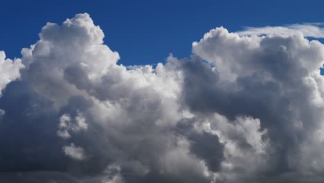 slow white puffy clouds with clear blue sky (ultrahd 4k) seamless loop