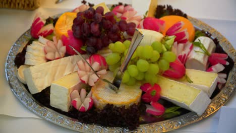 fruits and cheese lie on a plate.