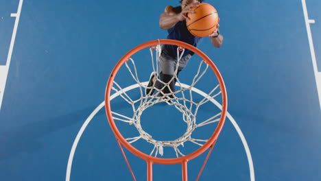dunking basketball, woman in action on court, showing athletic skills