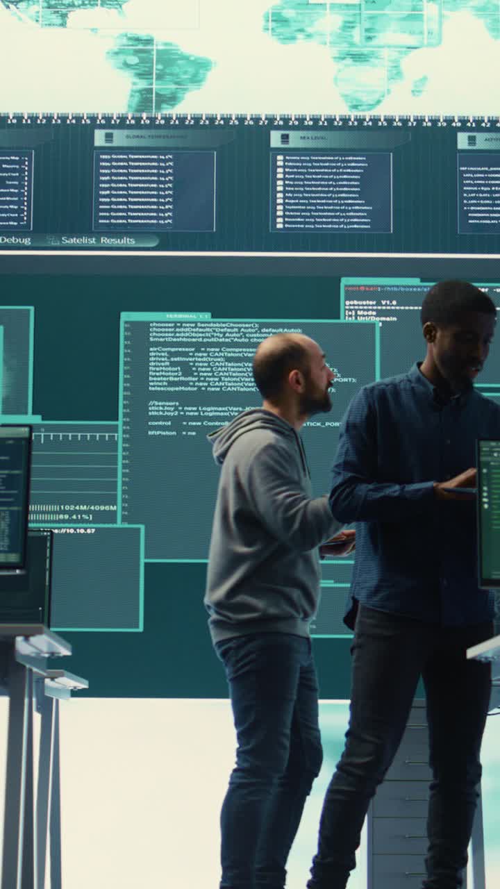 Two Male Software Developers Working in High-Tech Control Room