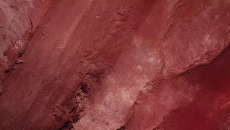 drone low flying above red volcanic dirt in kauai, hawaii during the day