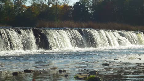 venta river rapid wide shot, the widest waterfall in europe in sunny autumn day, located in kuldiga city, latvia