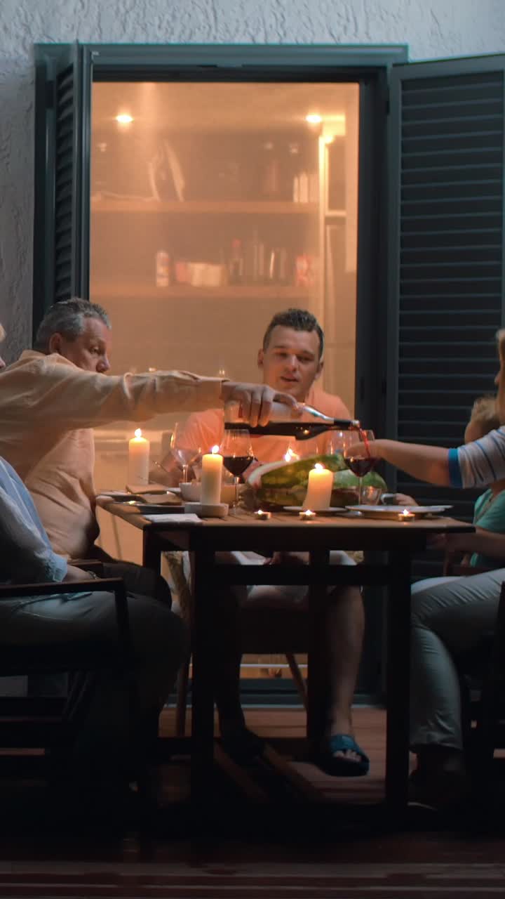 Family dinner with wine and candles