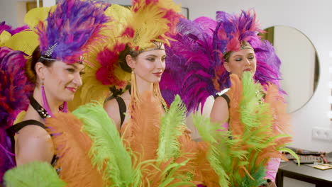 showgirls getting posing in front of a mirror