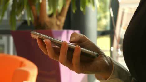 Businesswoman-using-her-phone-in-reception