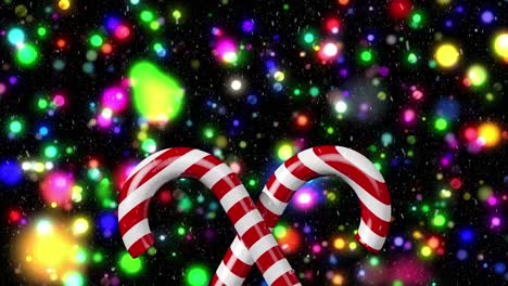 Animation-of-snow-falling-over-candy-canes-and-light-spots-on-black-backrgound