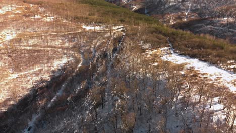 Aerial-panning-shot-of-snowy-mountain-roads