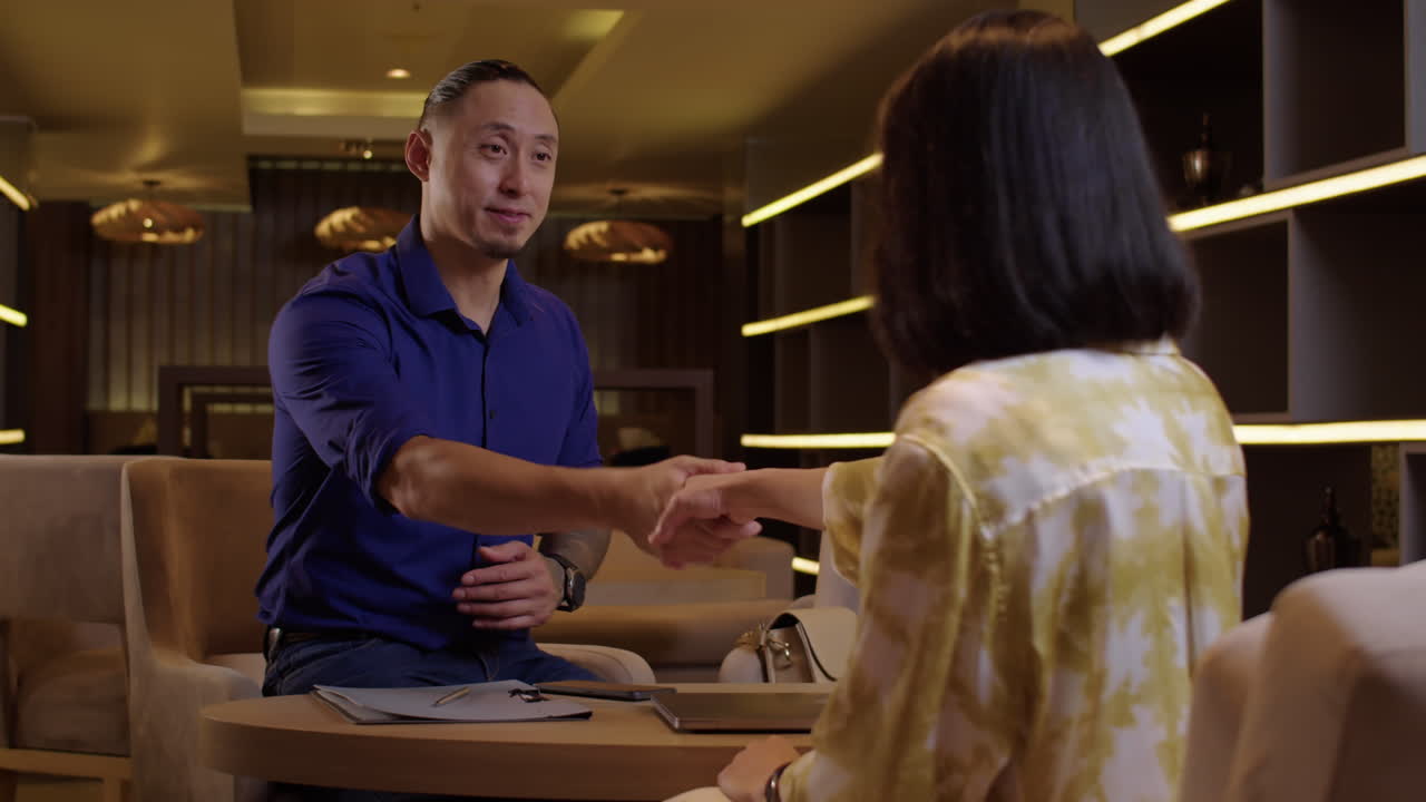 Entrepreneurs Giving Handshake at Office Lounge Area