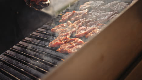 grilling pork at sunset barbecue