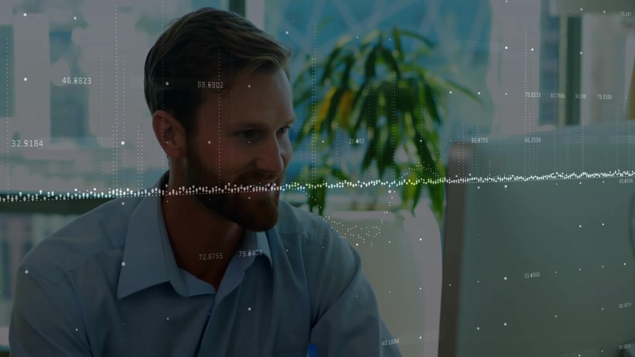 Male office worker analyzing data on computer desk near plant, with floating numeric readouts