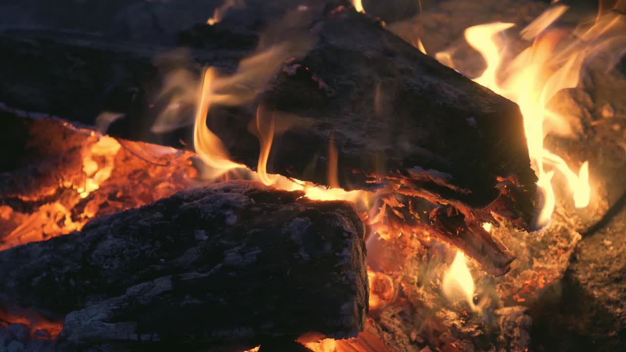 Campfire - cinematic close-up of wood and coals in a fire, high quality