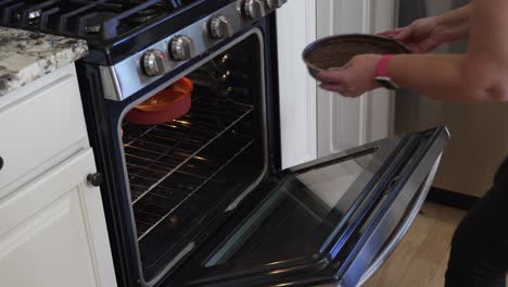 Placing-cake-pans-with-batter-in-the-oven