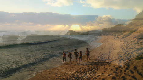 walking along sandy beach, group of people enjoying sunset with ocean waves