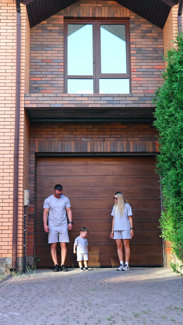 Kyiv, Ukraine, 25 May 2025: Matching family outfits out. A family enjoys time together at home, dressed in matching grey outfits, interacting in a friendly manner
