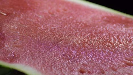 pulp of watermelon gyrating on black background