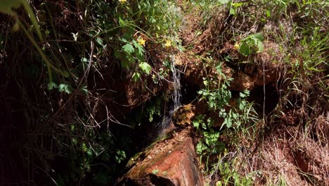 Static-shot-of-a-water-stream-flowing-through-porous-sandstone-rock