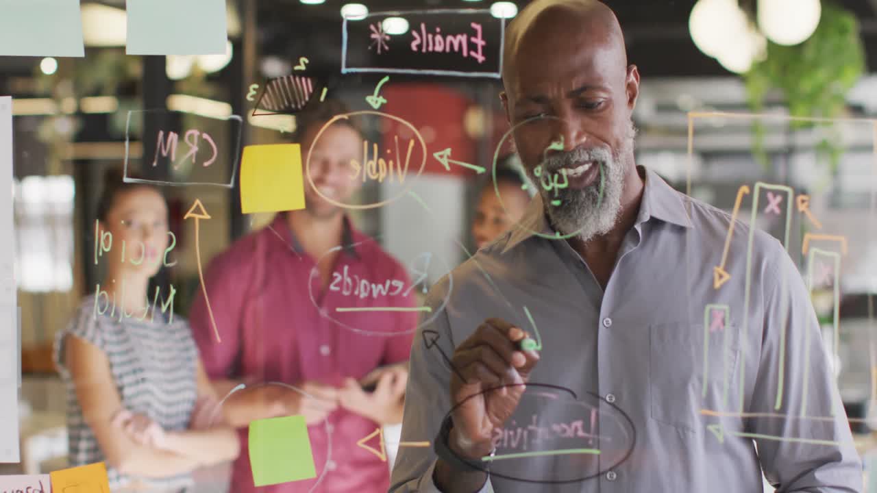 Happy diverse business people discussing work during meeting at office