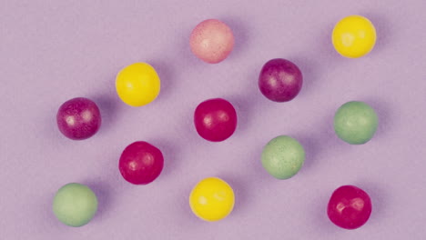 colorful round candies on purple background