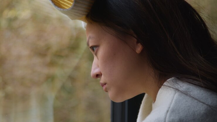 Close Up Of Stressed Or Anxious Woman Suffering With Depression Anxiety Loneliness Or Agoraphobia Leaning Against Window At Home 1
