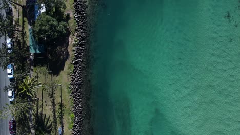 Scenic-high-view-over-a-crystal-clear-creek-at-a-popular-family-holiday-park-and-fishing-spot