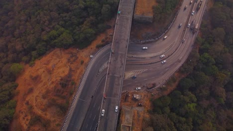 multi lane pune mumbai expressway through the mountain valley, lonavala, maharashtra, overhead drone shot