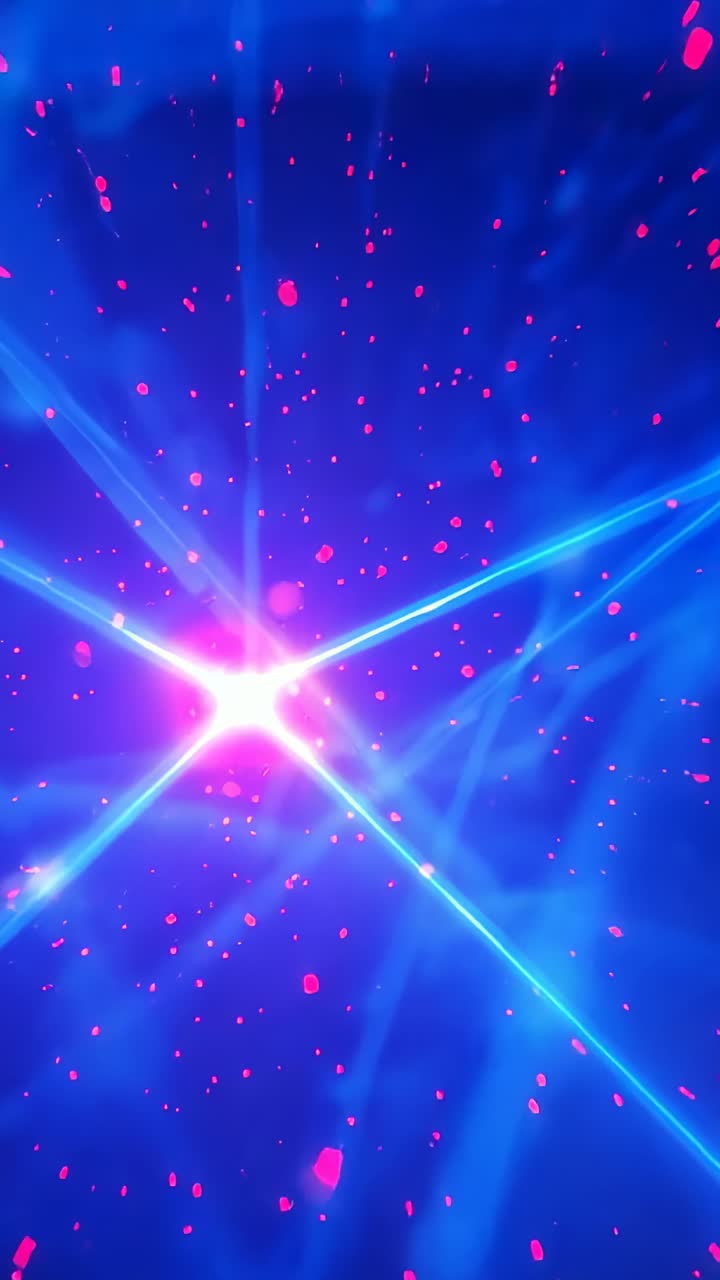 Vertical video: Light intensifying pulsing star sending beams over cosmic field with pink particles