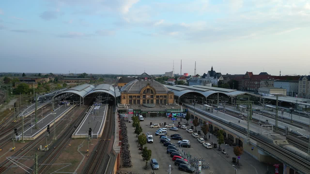 Aerial view of a modern train station with connecting tracks leading to suburbs and the city center. Marvelous aerial view flight overflight flyover drone