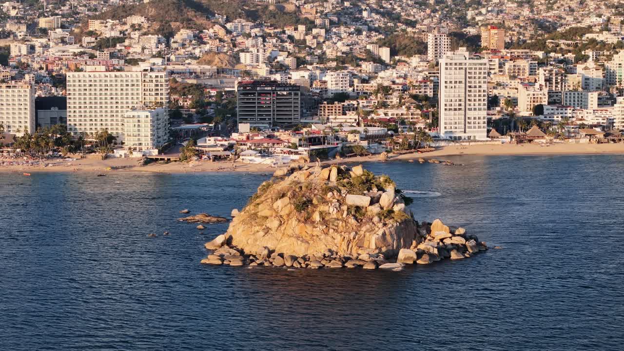 Rotational drone shot at acapulco bay at sunset