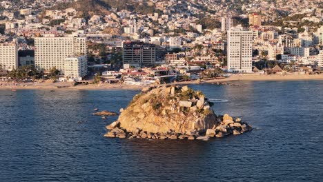 rotational drone shot at acapulco bay at sunset