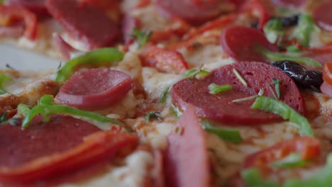 close up of a delicious pizza with pepperoni, tomatoes, and green peppers