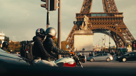 couple on a motorcycle near the eiffel tower in paris