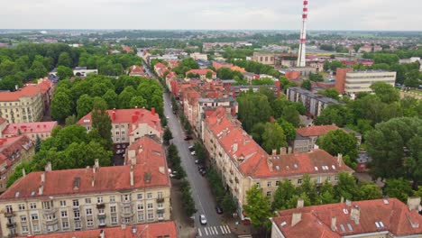 Klaipeda-establisher-aerial-shot,-flying-above-street-and-historical-buildings