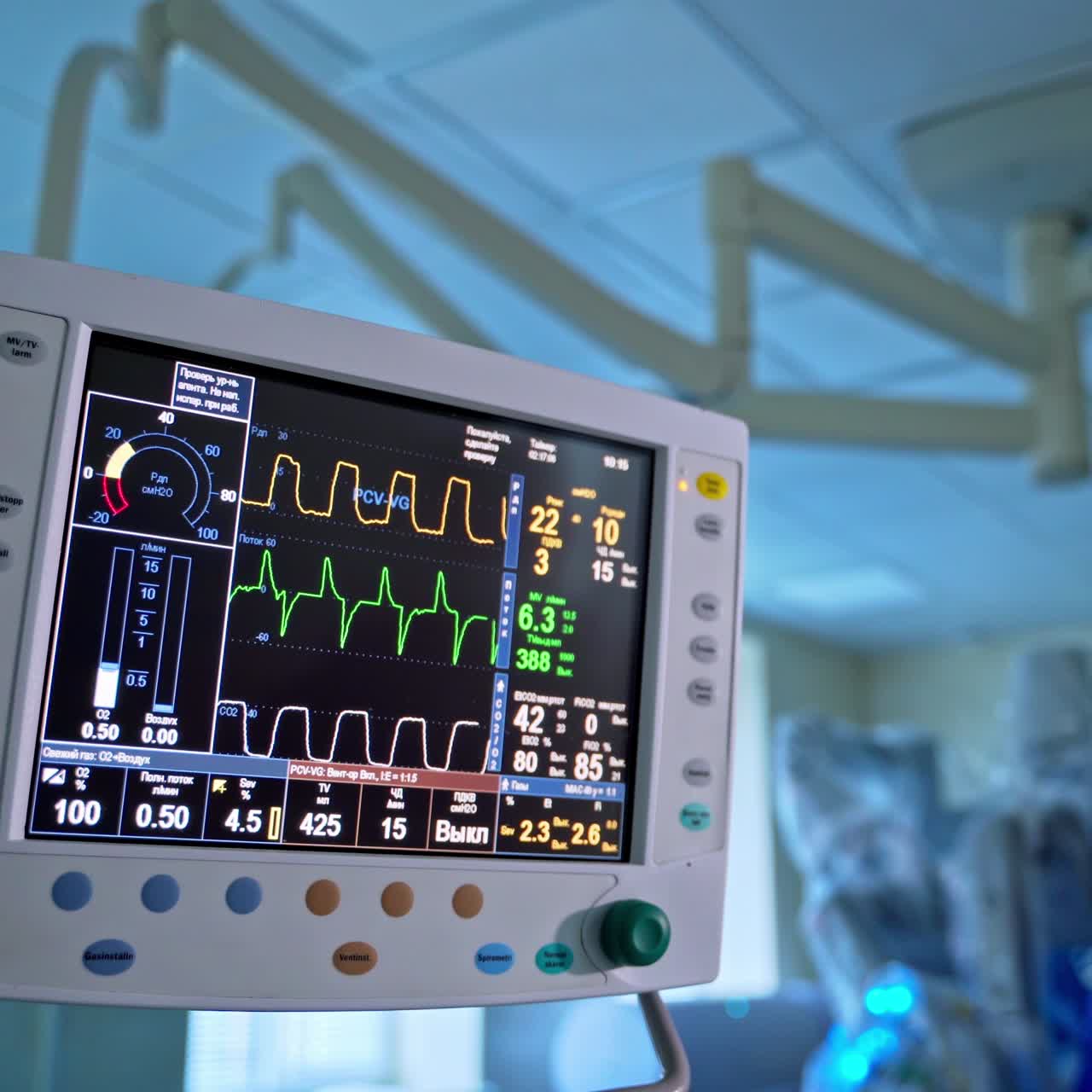 Patient's condition stable on health monitor. Screen shows normal vital signs of a patient in intensive care. Colorful lines on the monitor during surgery. Close-up.