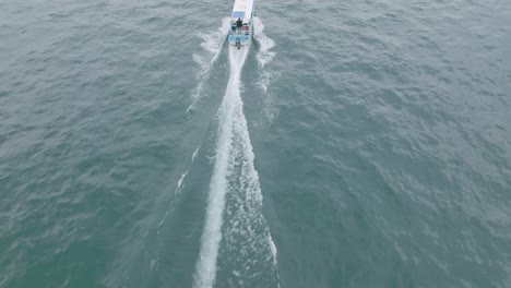 Aerial-footage-catching-up-to-and-flying-over-a-speedboat-heading-towards-the-shore-on-Lake-Atitlan-in-Guatemala