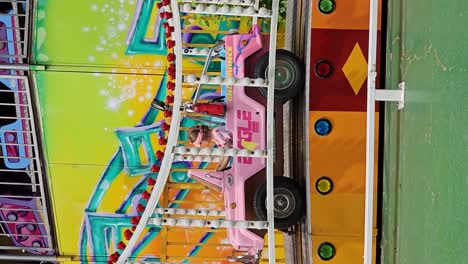 excited little kid child girl rides colorful car roller coaster for preschooler children at seoul land amusement park summer time - vertical tracking