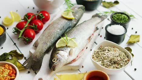 spices and tomatoes around fish