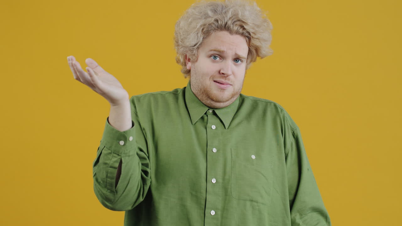 Confused Man in Green Shirt