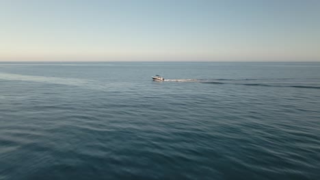 Single-boat-cruising-across-aerial-view-Spanish-ocean-seascape-water-surface