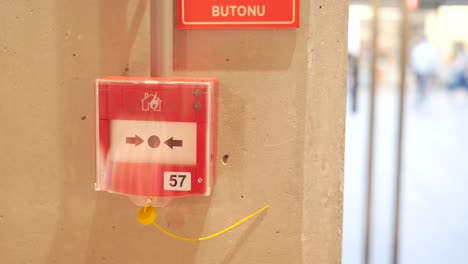 red fire alarm box on a concrete wall