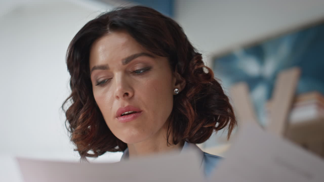 Closeup serious employee reading document at company office. Financial manager