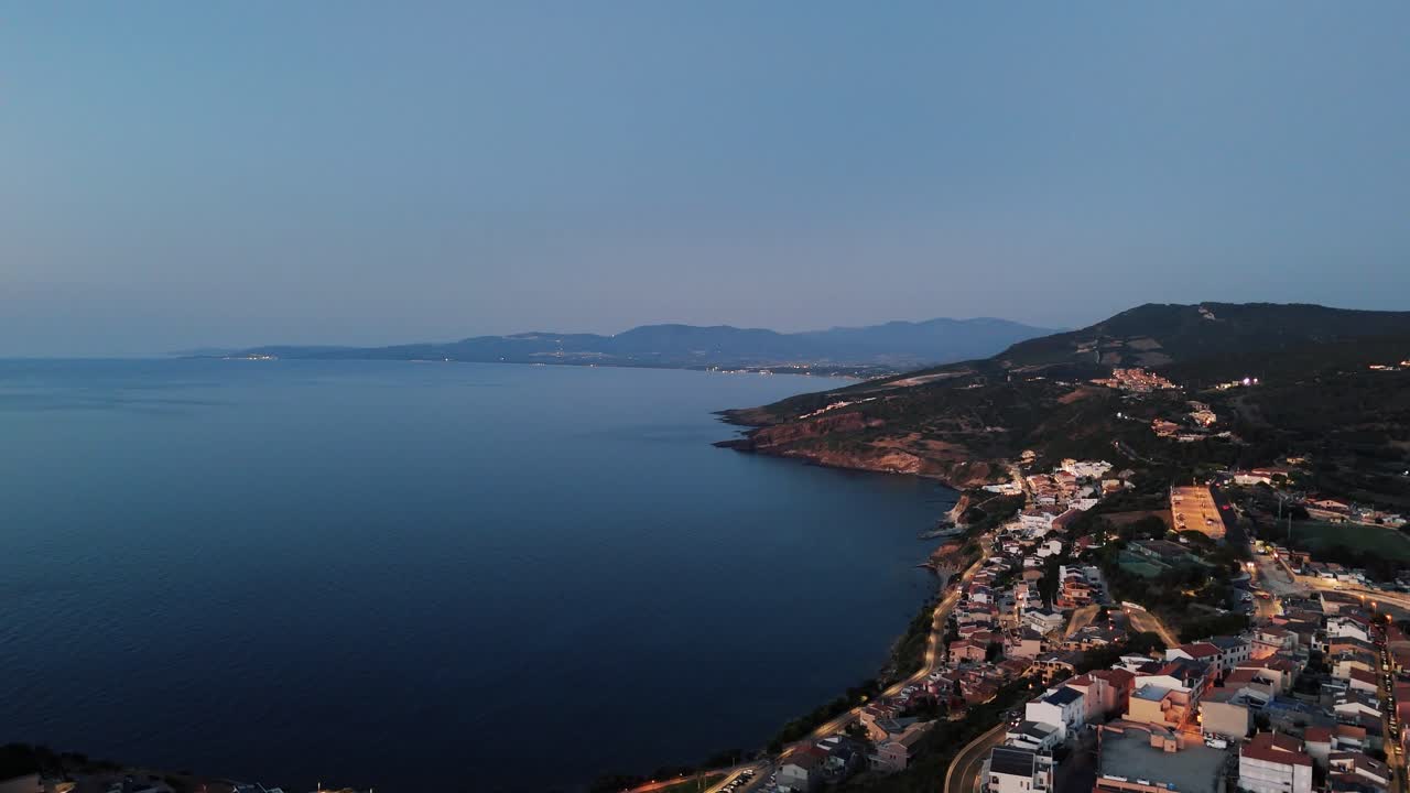 Aerial view of Castelsardo, Sardinia at dusk, tranquil and scenic coastline