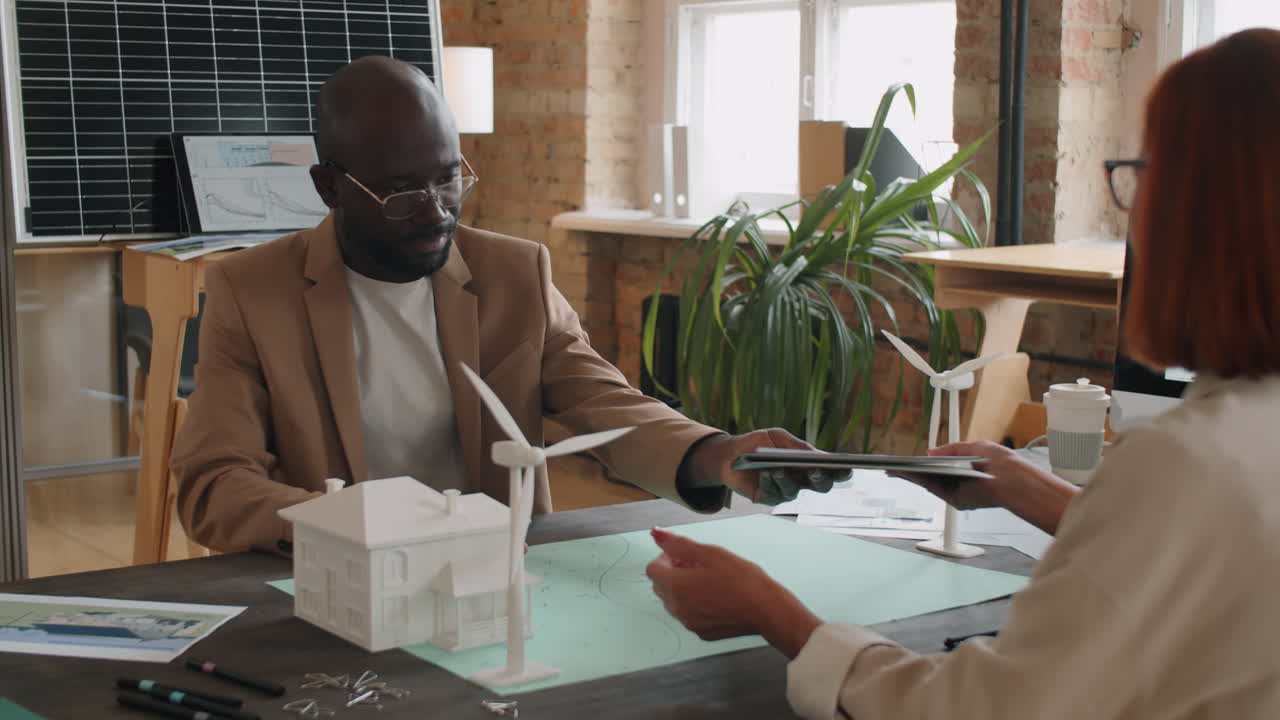Business Partners Signing Renewable Energy Contract and Shaking Hands
