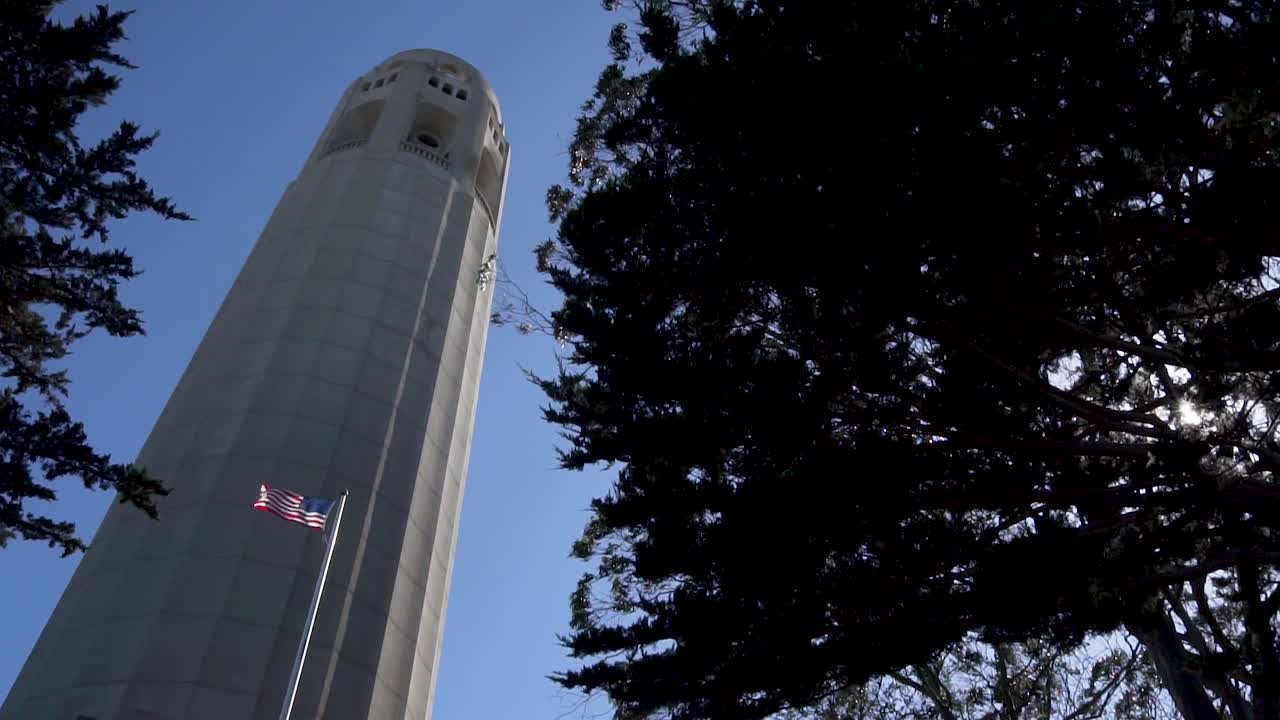 Coit Tower, Telegrah Hill, San Francisco, California USA. American National Flag Waving Under Designated Landmark