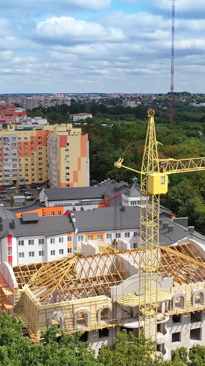 Large plant surrounded by green nature. Construction of the manufacturing in the countryside in summer. Modern industrial complex on field. Aerial view Vertical video