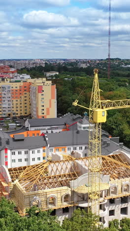large plant surrounded by green nature. construction of the manufacturing in the countryside in summer. modern industrial complex on field. aerial view vertical video