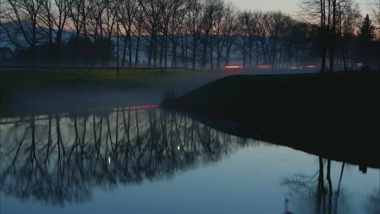 Car Traffic Light Reflections In The Water In The Evening. 4K Timelapse