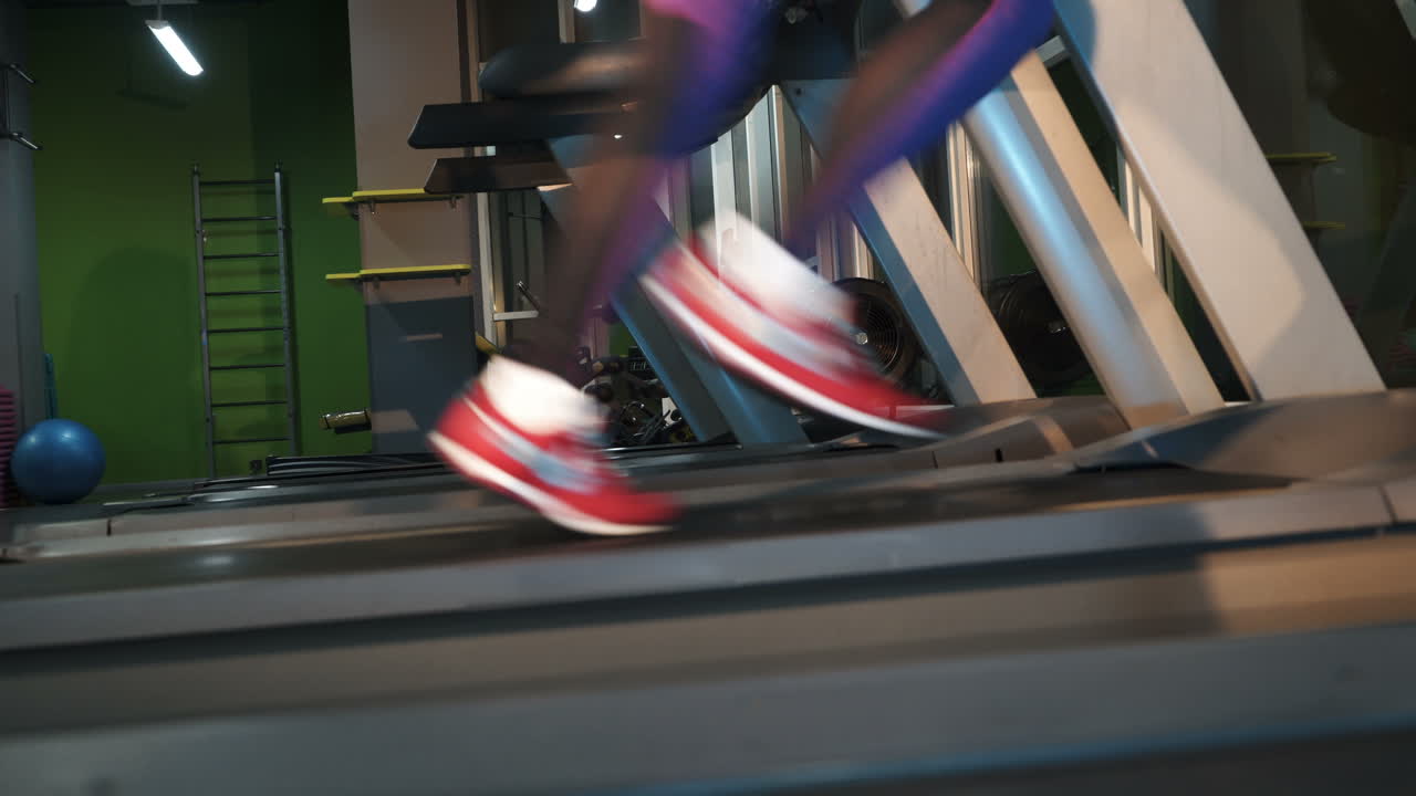 Female muscular feet in sneakers running on the treadmill at the gym. Concept for fitness, exercising and healthy lifestyle.