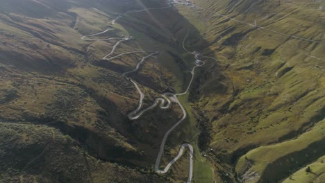 aerial of a mountain road in the italian dolomites during sunset