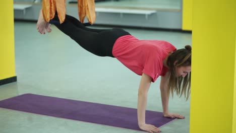 woman practicing aerial yoga plank
