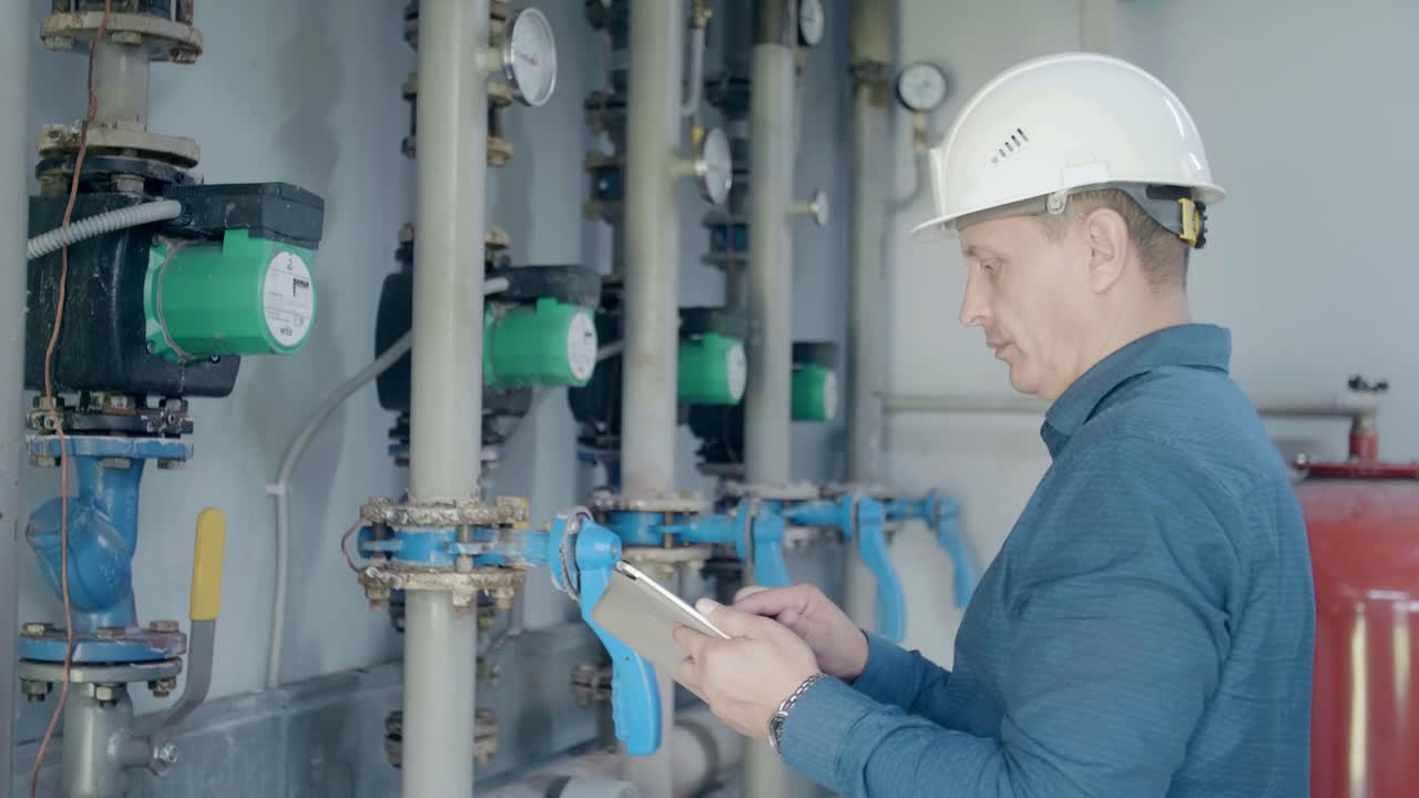 Engineer Inspecting Heating System